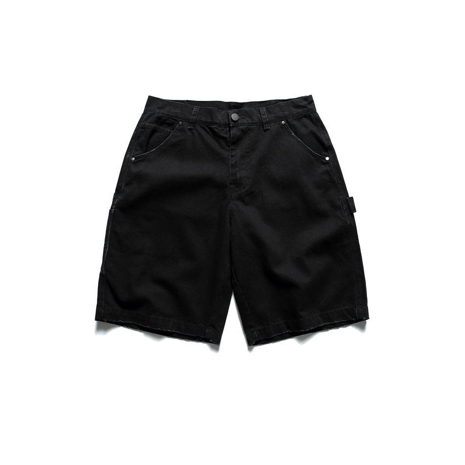 Black carpenter-style knee-length shorts, flat lay front view with button fly, rivets and frayed hem