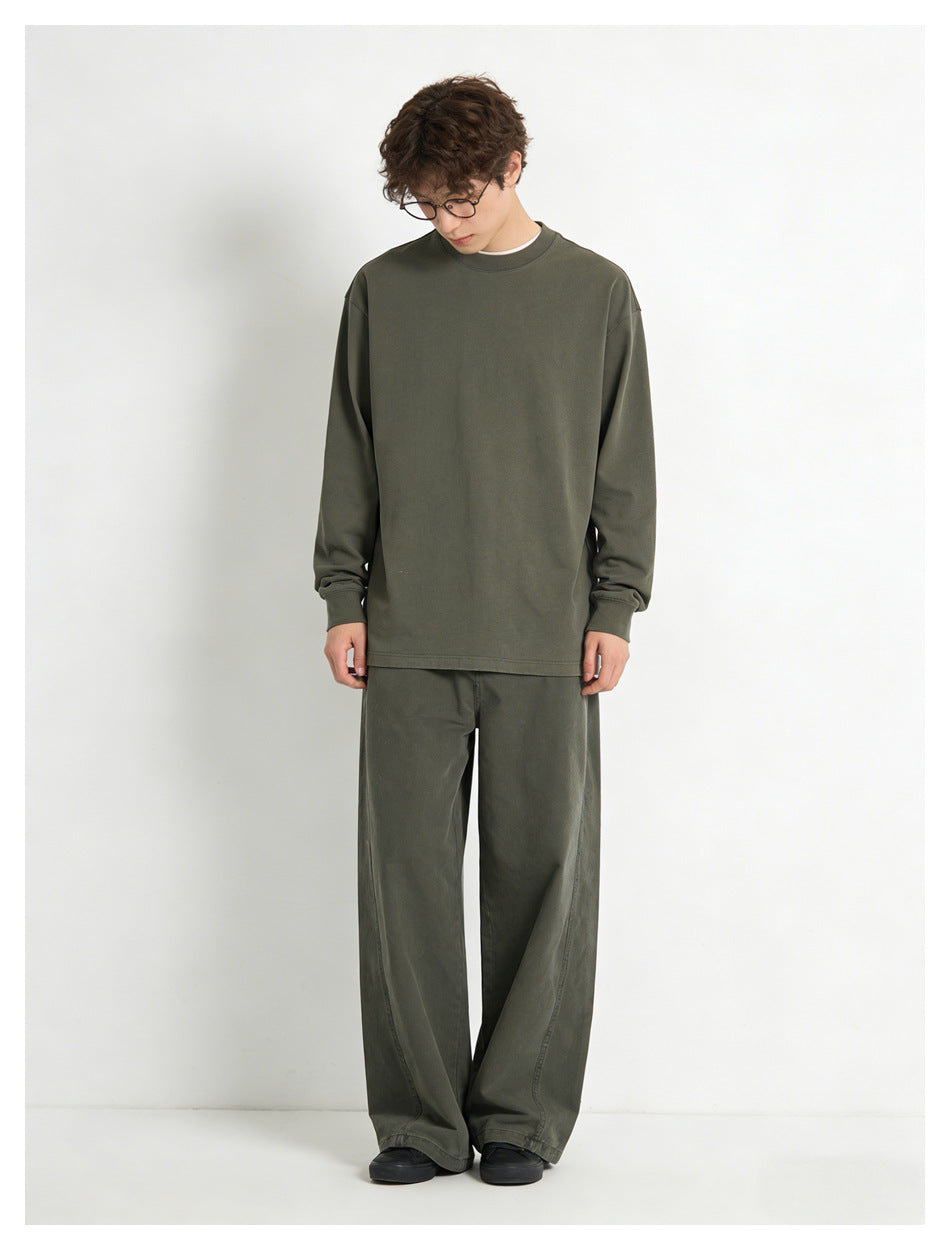 Model wearing army green wide-leg pants with an olive sweatshirt and black shoes, front view