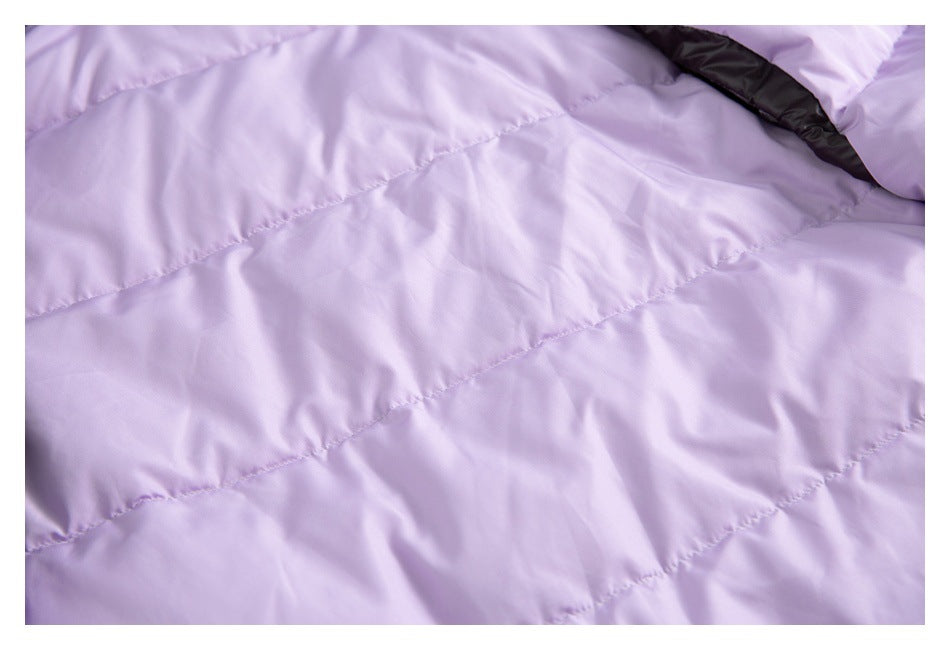 Close-up of lavender quilted jacket lining with a section of black trim.