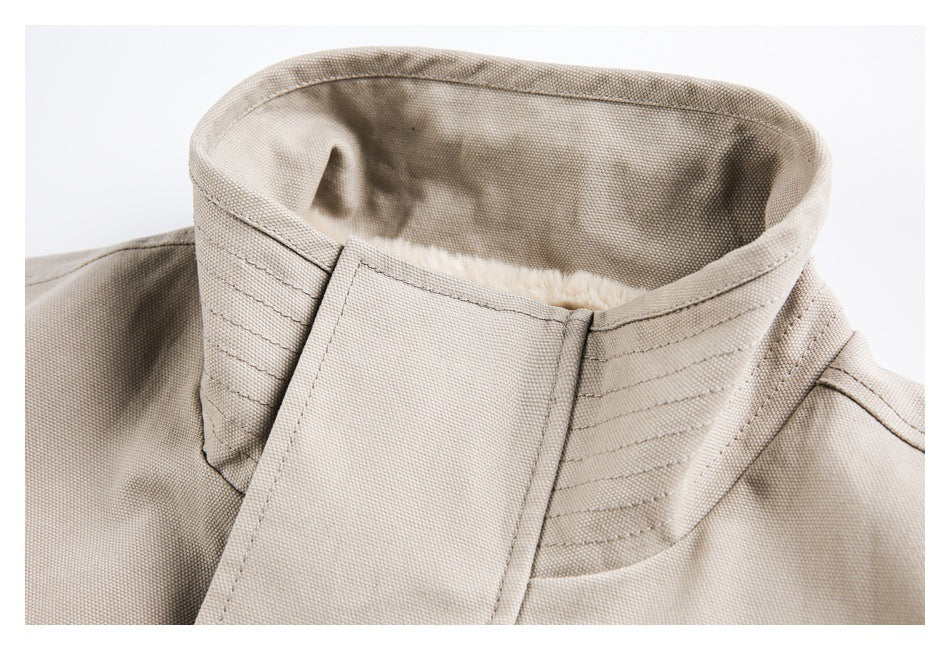 Close-up of the taupe jacket's high collar, layered stitching, and a glimpse of the cream lining.