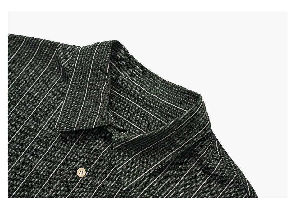 Close-up of the dark striped shirt collar, neckline, and a light-colored button.