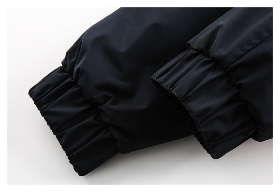 Close-up of a black garment with gathered, elasticized cuffs and visible stitching.