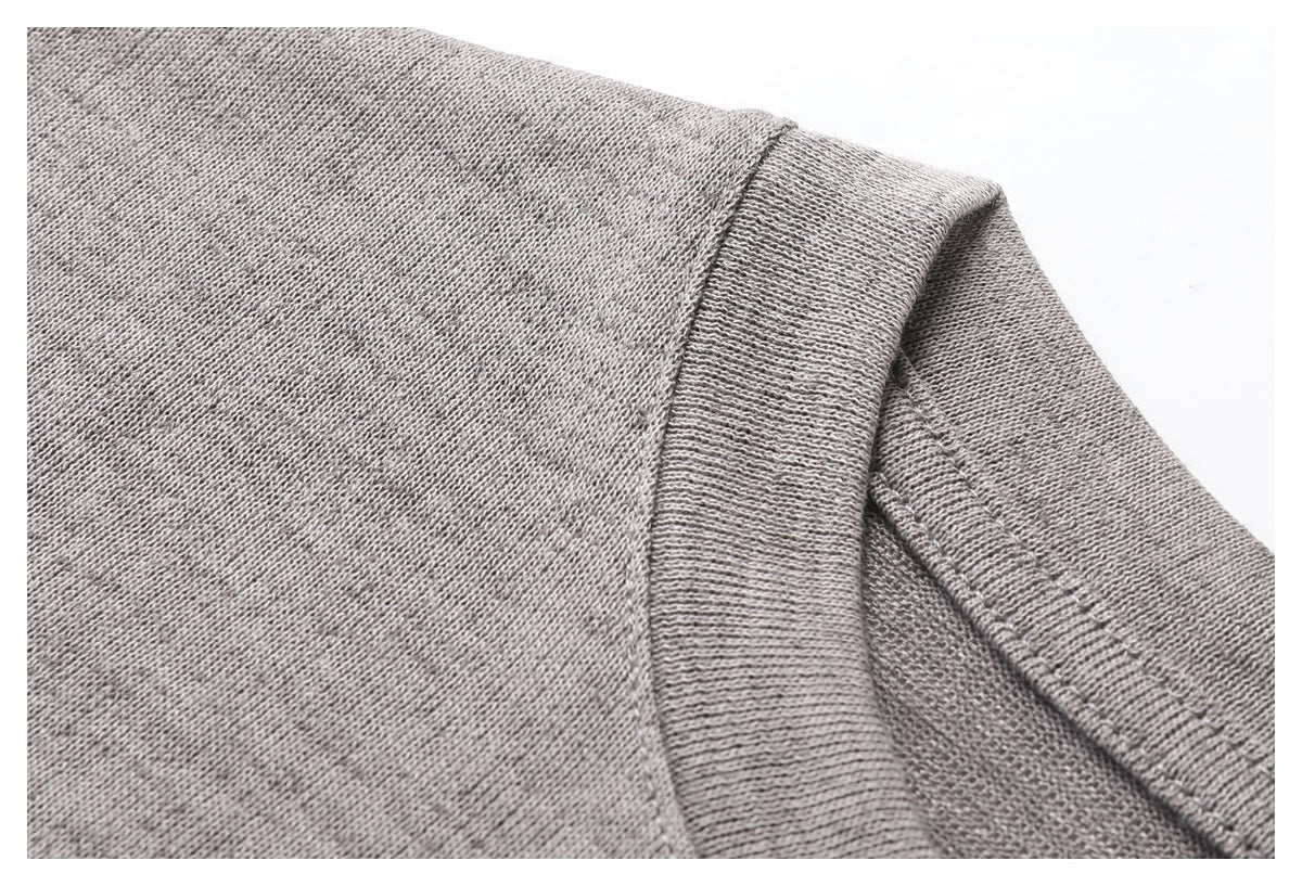 Close-up of gray T-shirt shoulder and neckline stitching.