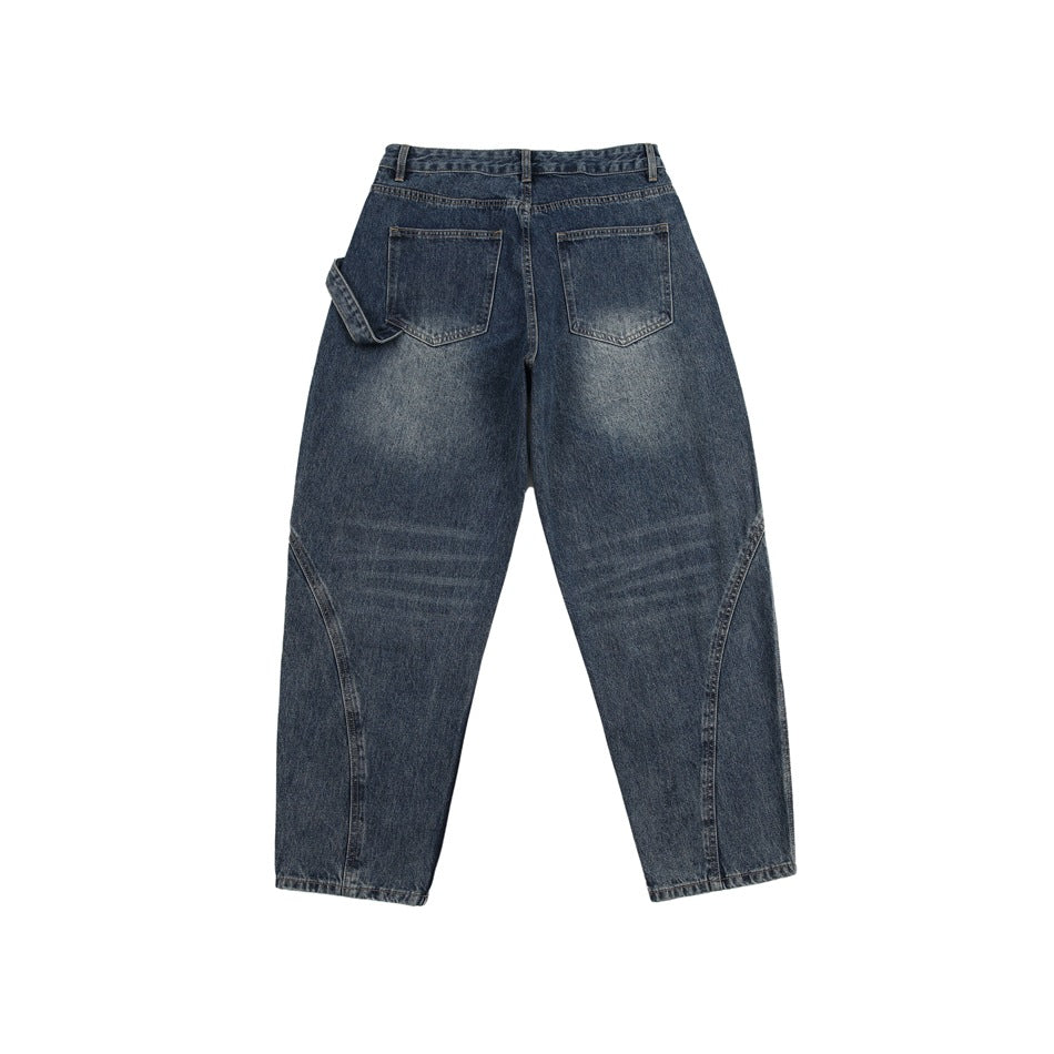 Blue washed denim jeans, back flat view with two patch pockets and curved leg seams