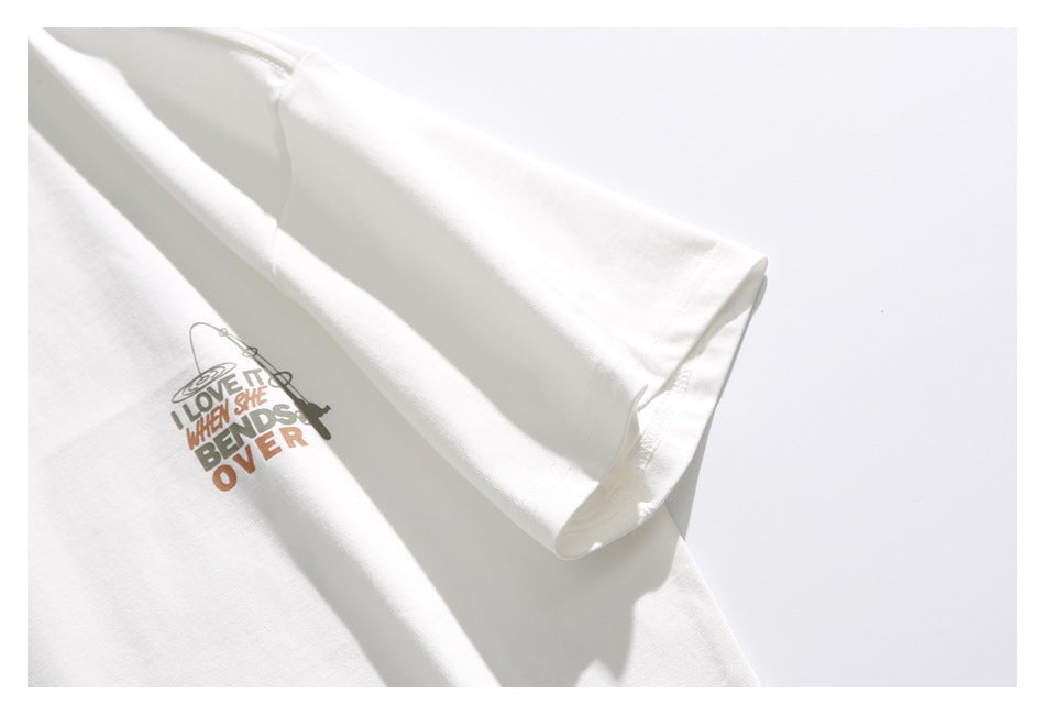 Close-up of the white T-shirt's short sleeve and small multicolor chest graphic with English lettering.
