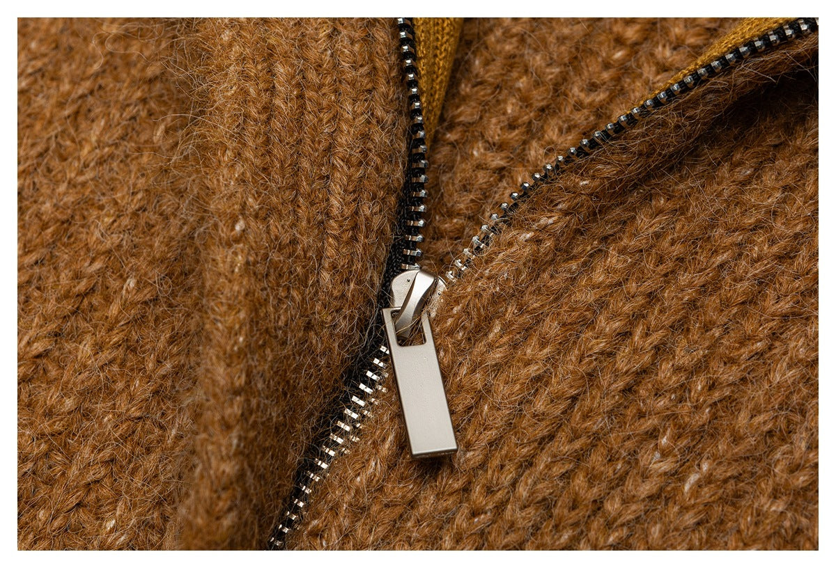 Close-up of a metal zipper on the brown fuzzy knit garment.