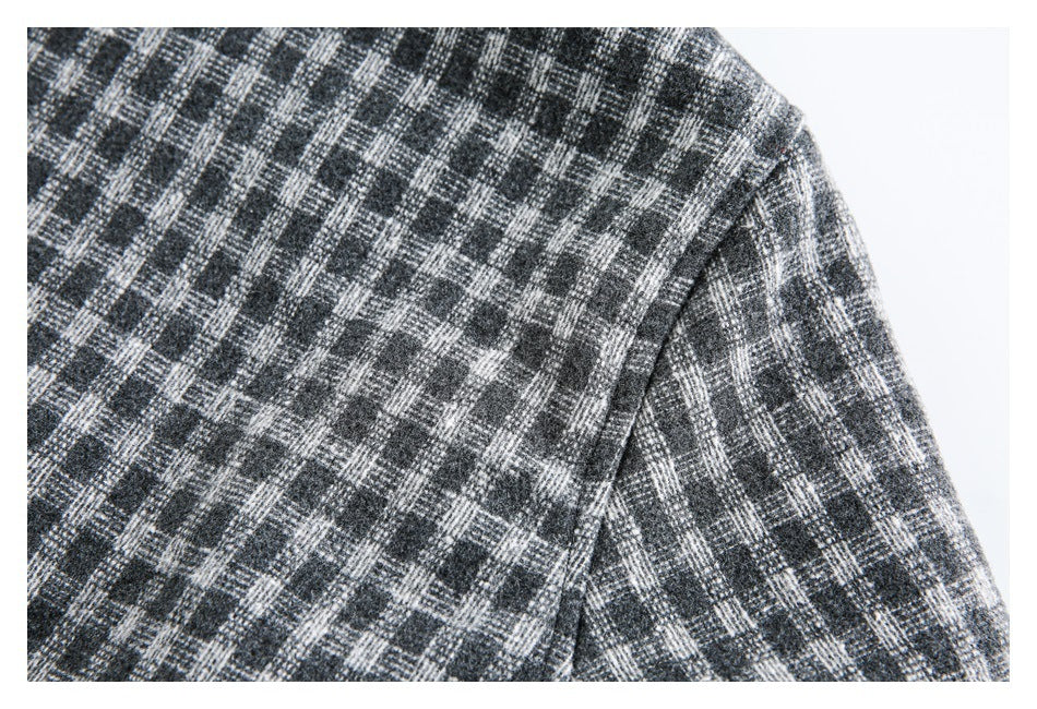 Close-up showing the shoulder and sleeve seam of a charcoal and gray plaid jacket.