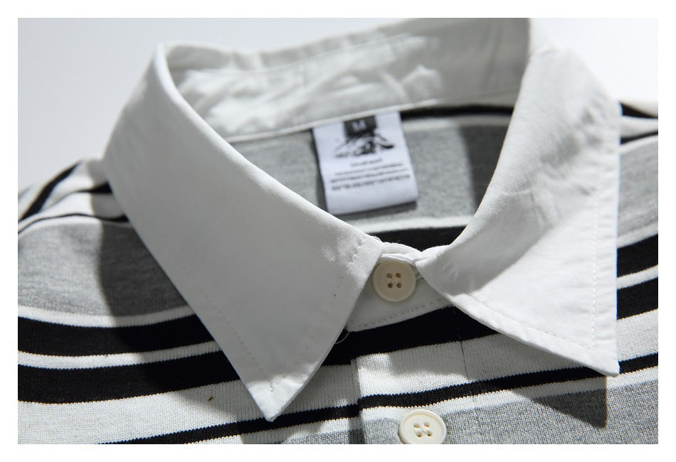 Close-up of the white collar, top button, and sewn-in neck label on the striped shirt.