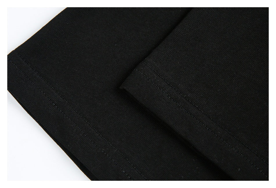 Close-up of black garment hems with visible rows of stitching.
