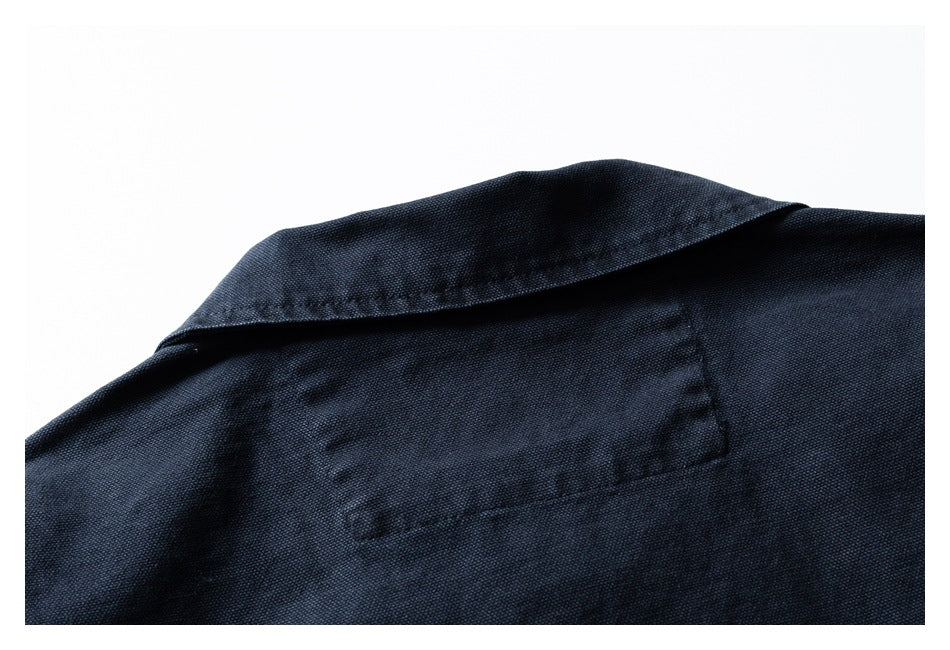 Close-up of a dark navy garment collar and back panel seam.