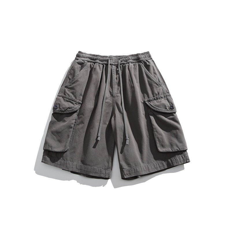 Gray cargo shorts flat lay with drawstring waistband and button-flap cargo pockets