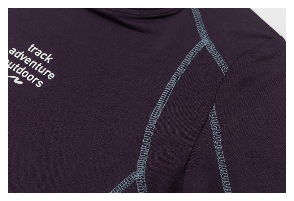 Close-up of blue-gray overlock seams crossing the shoulder area of a dark plum garment.