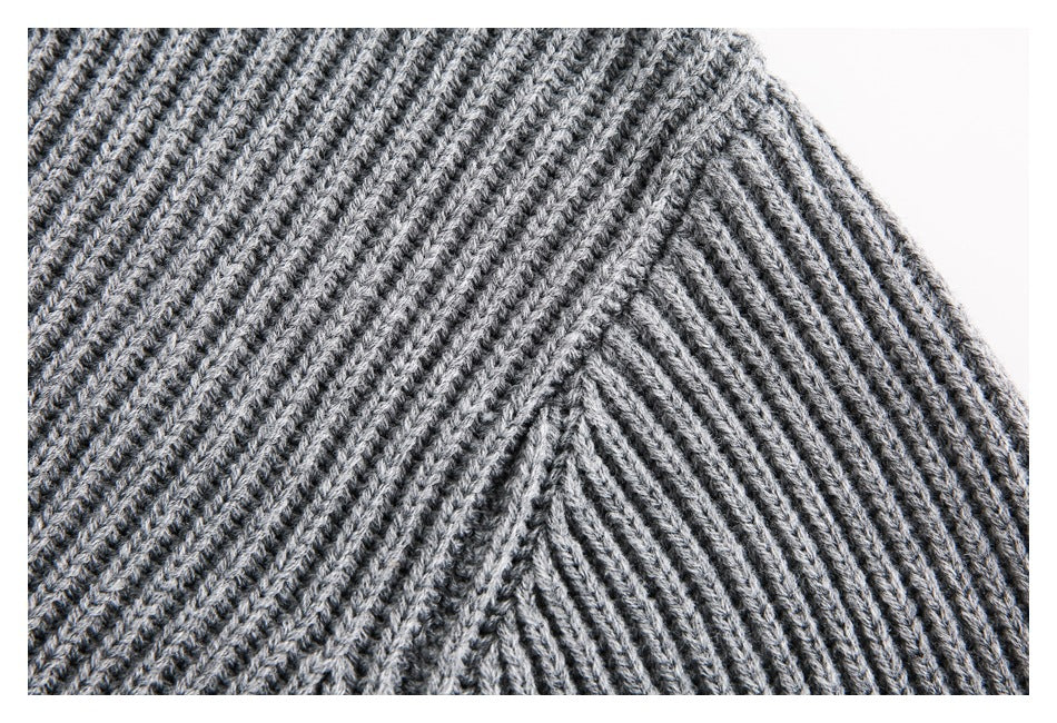 Close-up of the gray sweater's ribbed knit and shoulder seam.