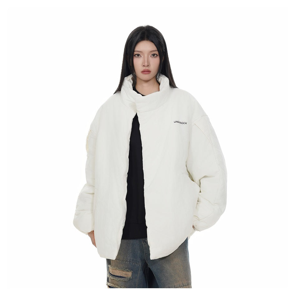 Model wearing an off-white stand-collar padded jacket open over a black top, close three-quarter view