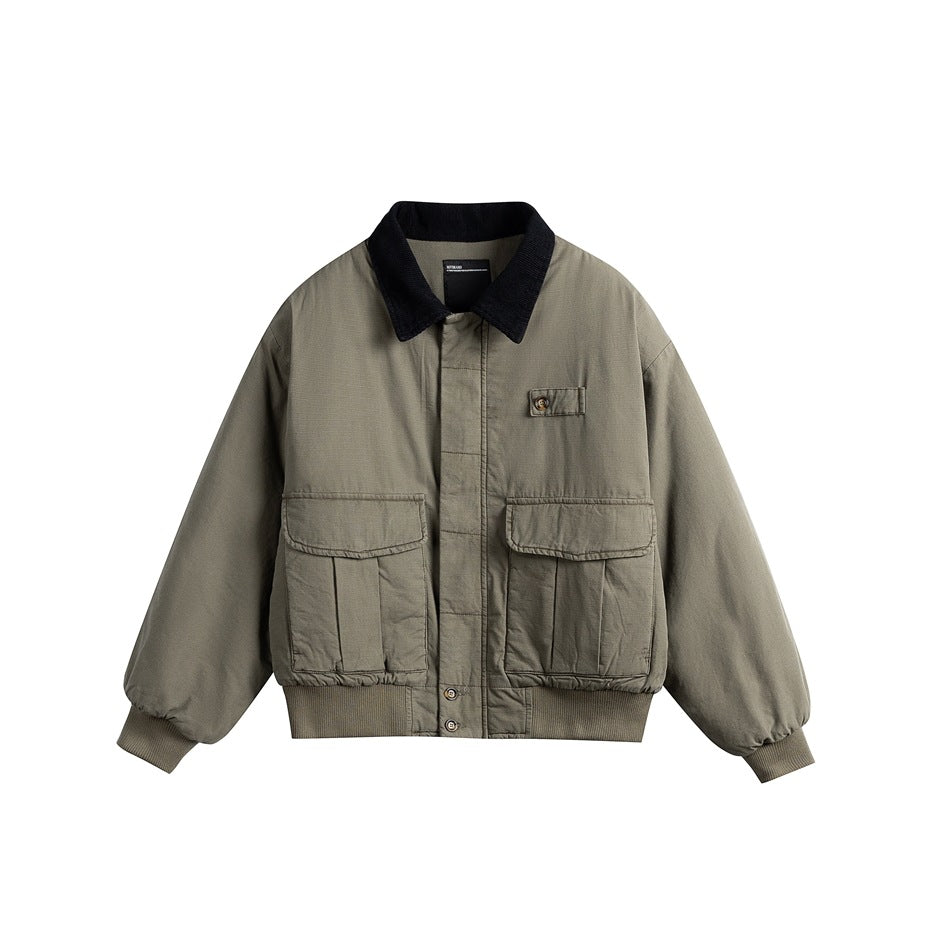 Gray-green padded bomber-style jacket with navy corduroy collar, flap pockets and ribbed hem, front flat lay