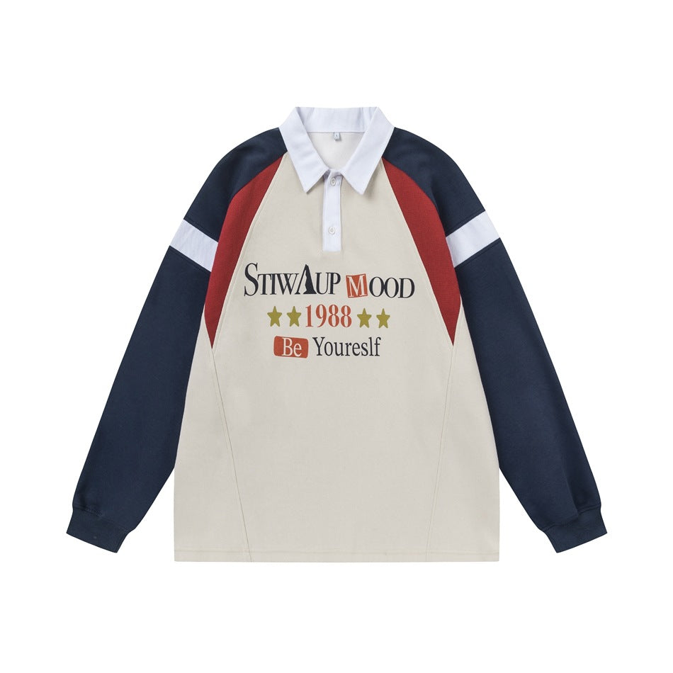 Beige polo sweatshirt with navy raglan sleeves, red side panels, white collar and a front graphic print