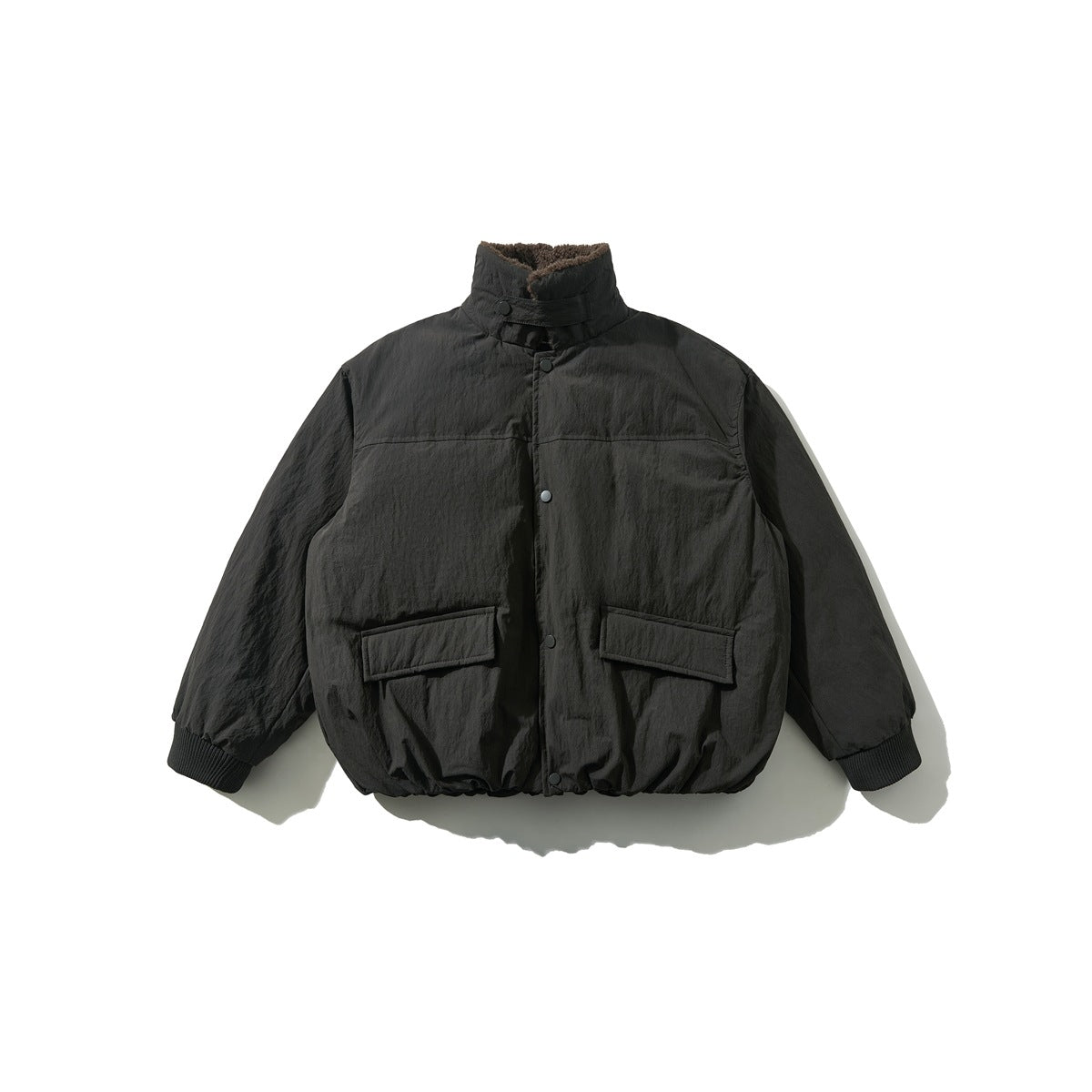 Front view of a dark jacket with a high collar, brown textured lining, snap closure, flap pockets, and ribbed cuffs.
