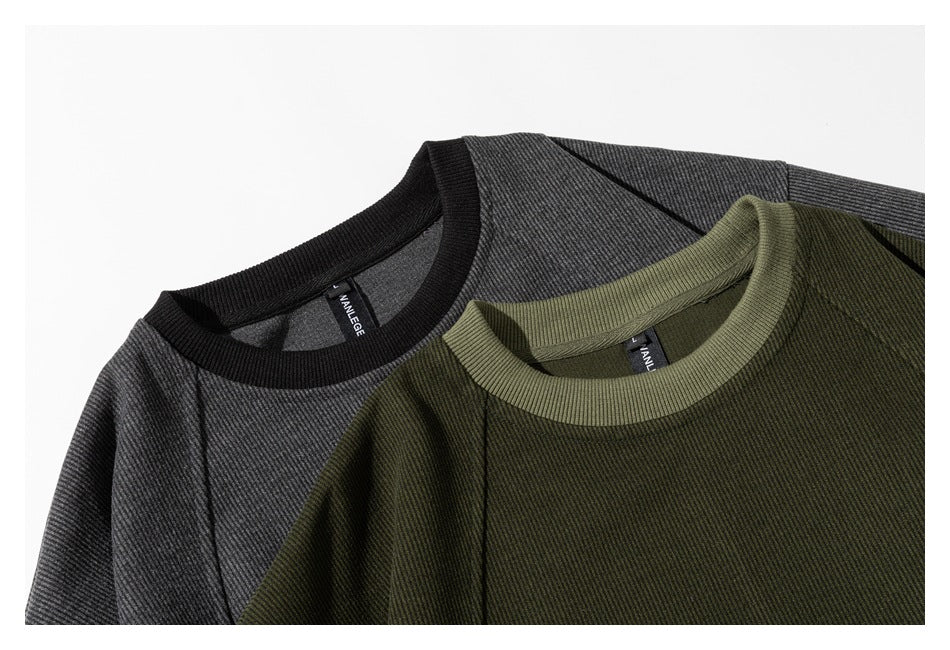 Close-up of olive and charcoal sweatshirts showing their ribbed crew necks and shoulder seams.