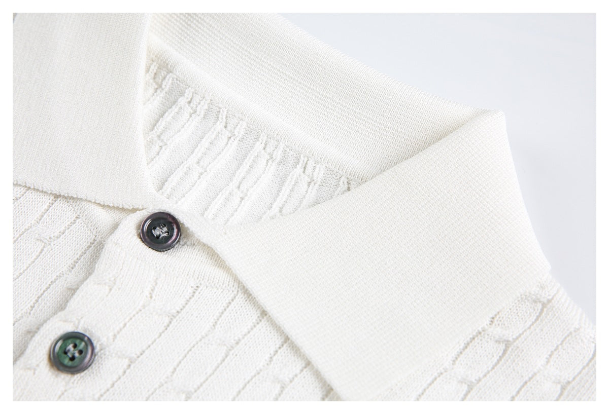 Close-up of an ivory knit polo collar and placket with dark buttons and raised stitch details.