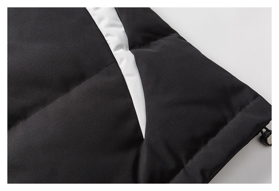 Close-up of black padded garment panels with a white insert and a small black edge toggle.