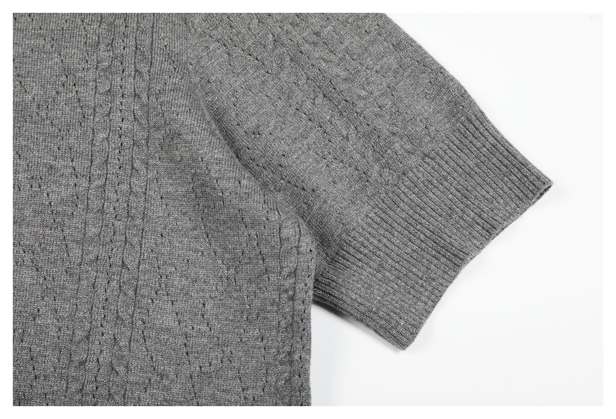 Close-up of a short sleeve and ribbed cuff on the gray knit top.