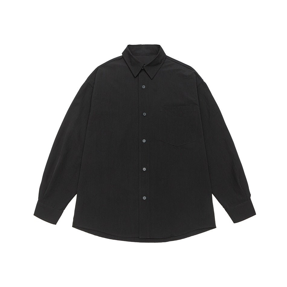 Black long-sleeve button-up shirt with pointed collar, chest pocket, and curved hem, shown from the front.