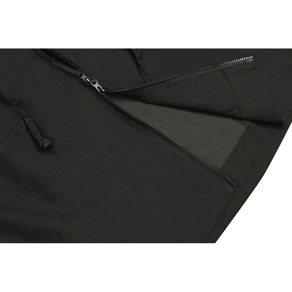 Close-up of a black garment showing a diagonal zipper and a zippered pocket.