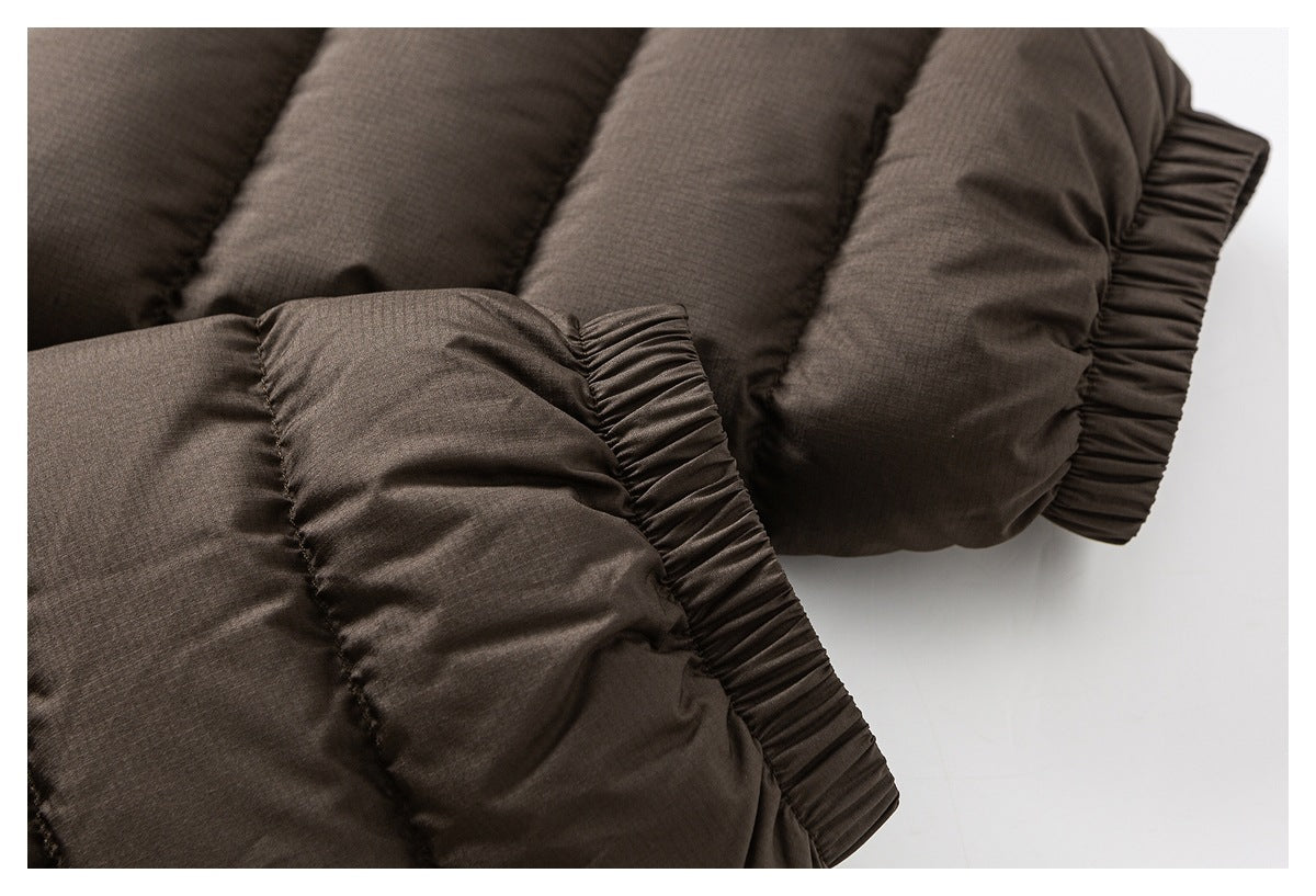Close-up of a dark brown padded jacket sleeve with a gathered elastic cuff.