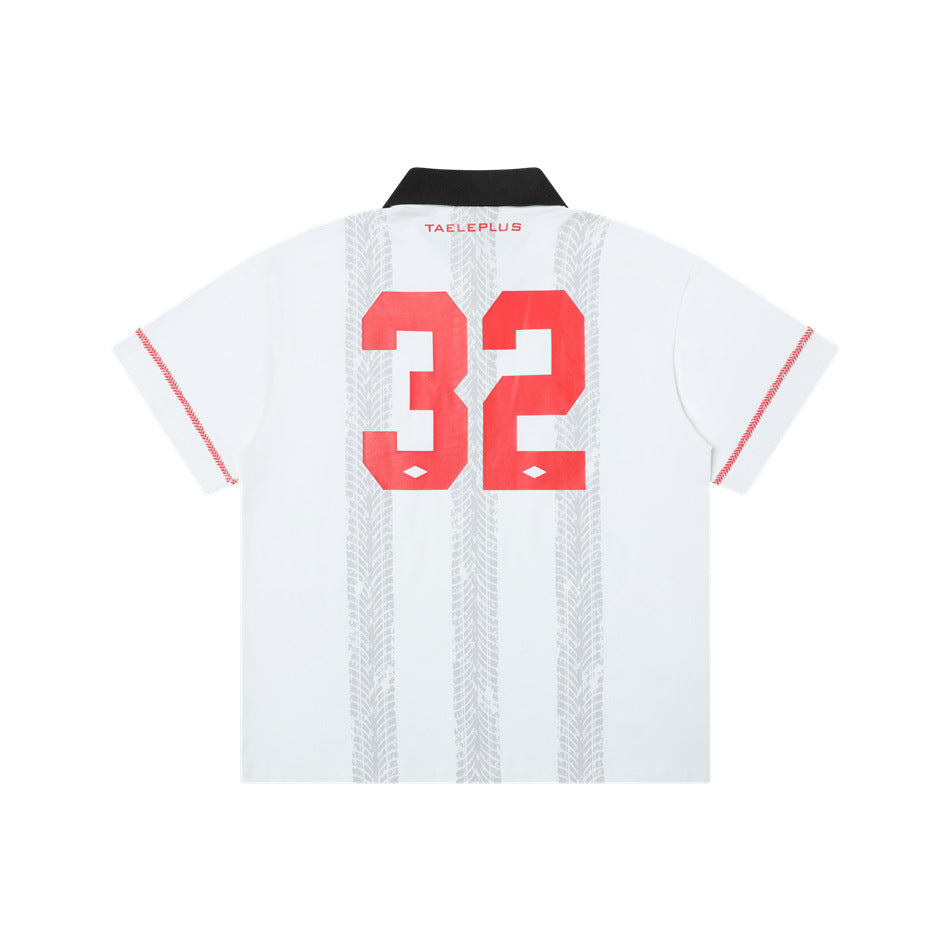 Back view of a white polo shirt with a black collar, gray vertical patterns, red sleeve accents, and a large red 32.