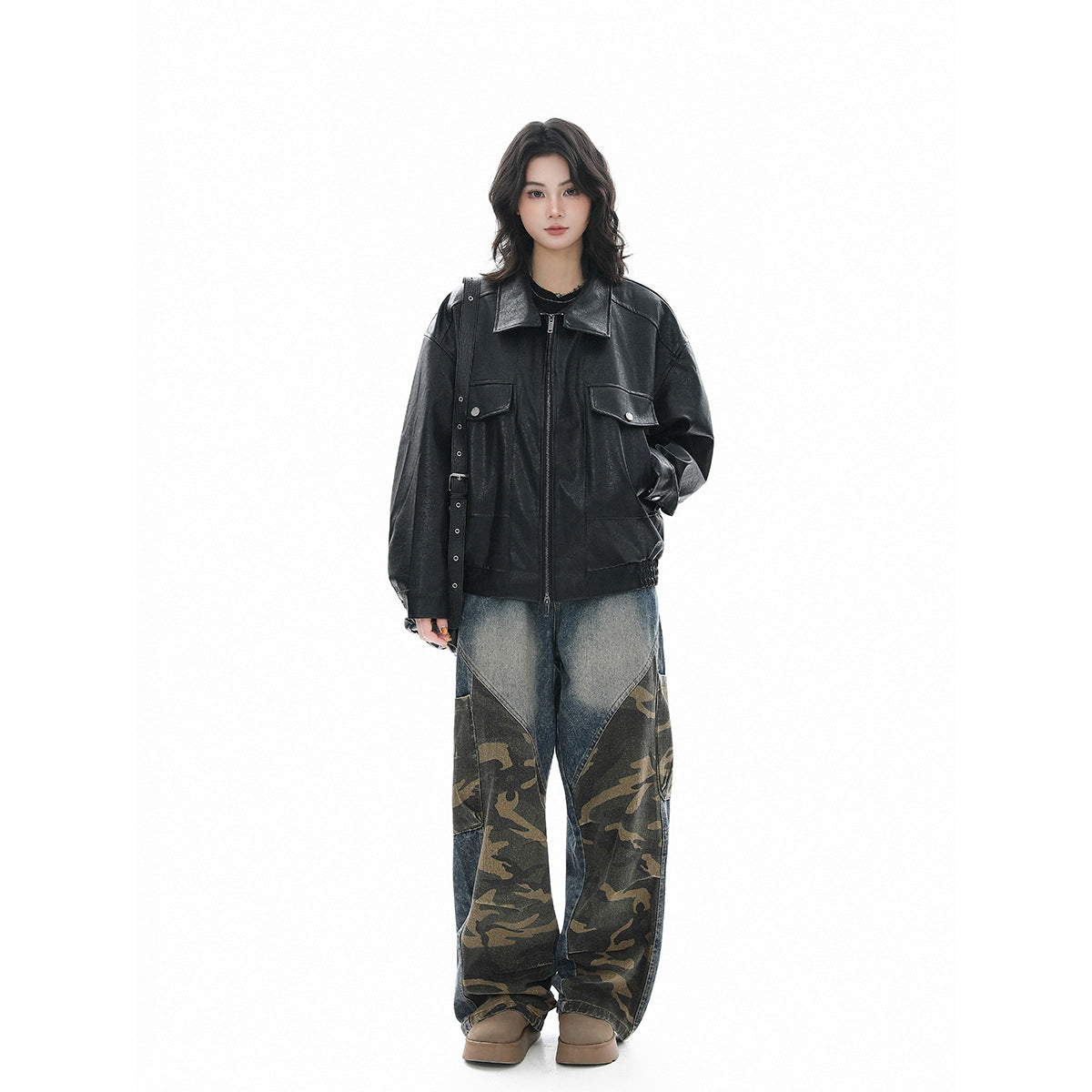 Full-length model view of an oversized black jacket with a zip front, wide collar, and buttoned flap chest pockets.