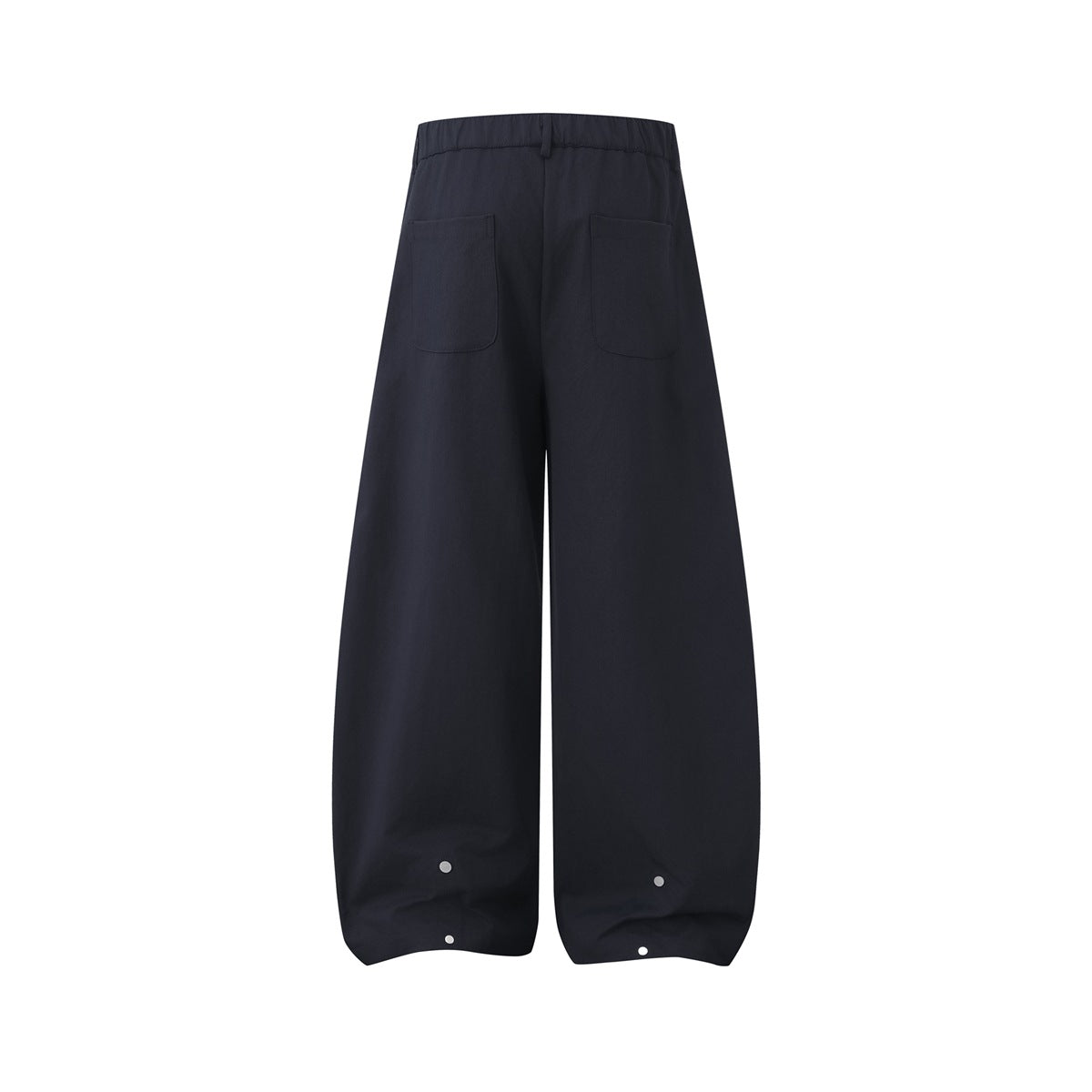 Back view of navy wide-leg trousers with an elastic waistband, two patch pockets, and snap fasteners at the hems.