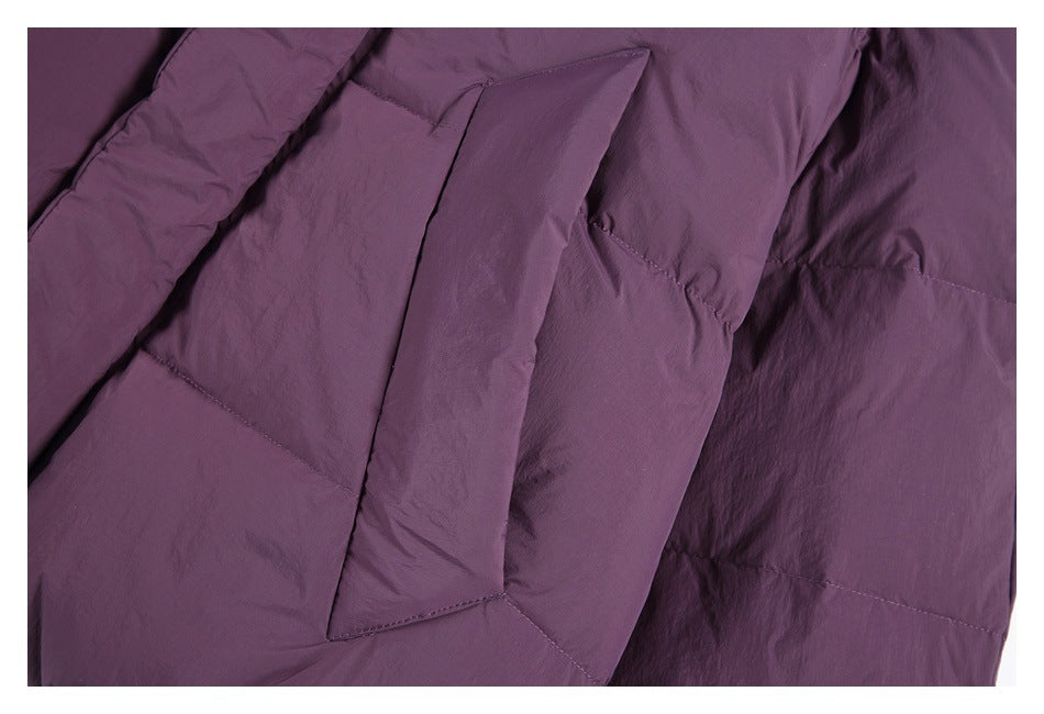 Close-up of a plum-purple garment showing a large angular pocket and stitched panels.