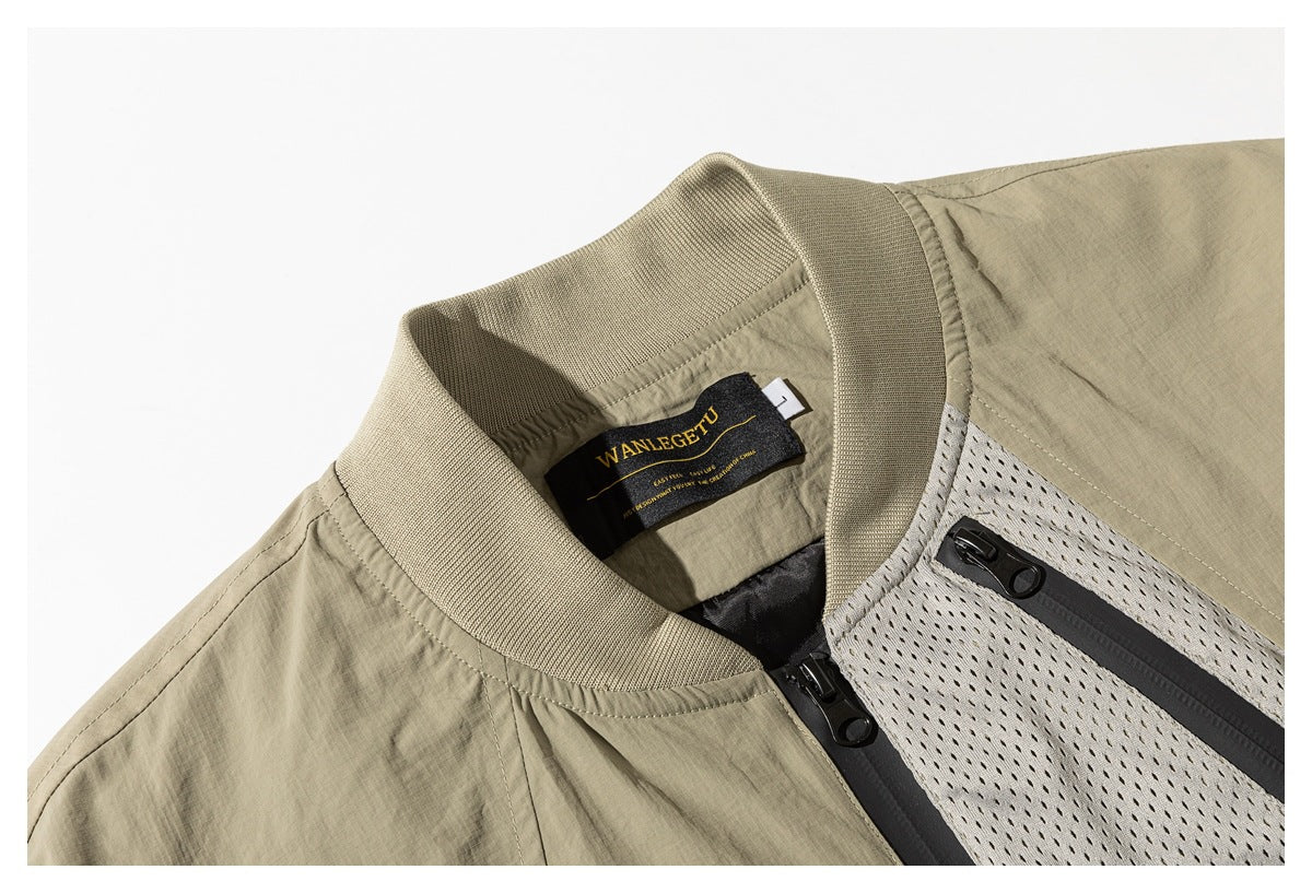 Close-up of a khaki jacket's ribbed collar, neck label, front zipper and mesh chest panel.