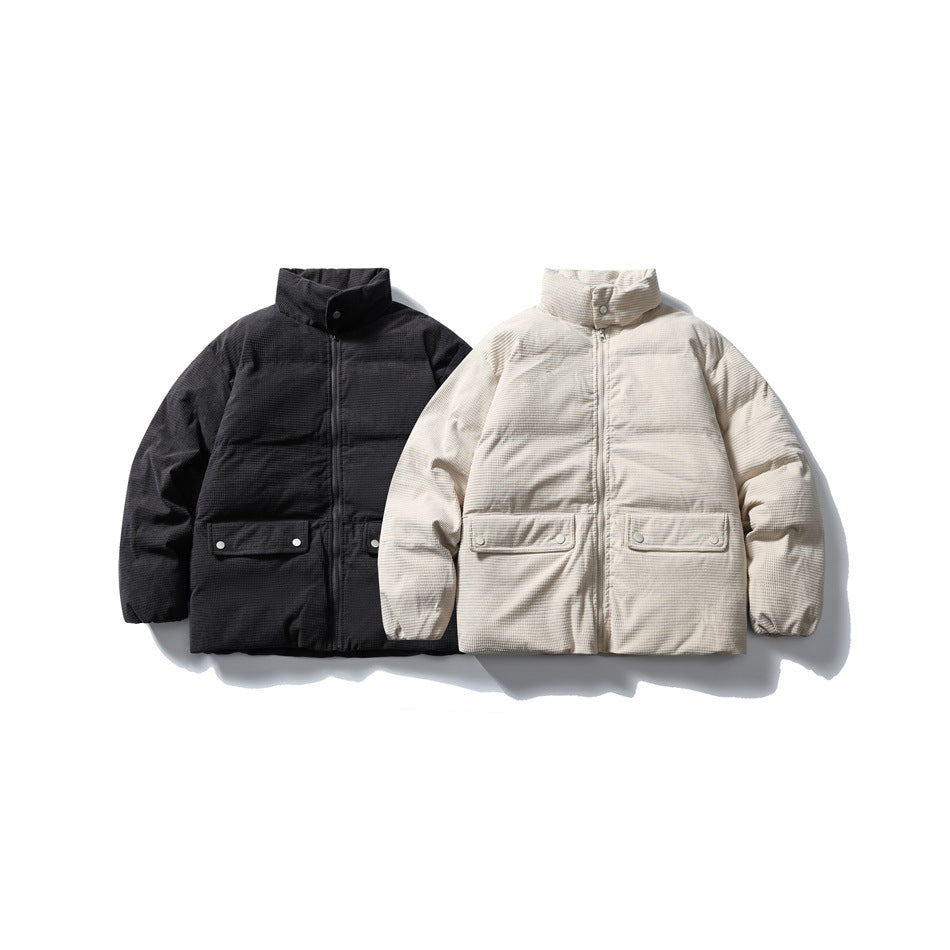 Two padded jackets shown from the front: one black and one cream, both with high collars and snap-flap pockets.