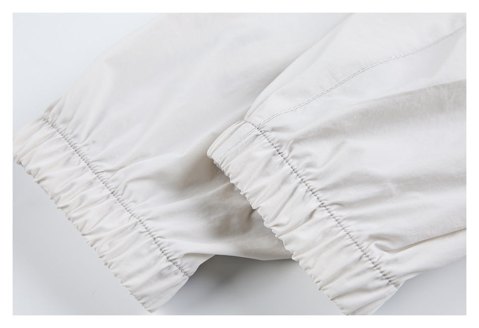 Close-up of the white jacket's elasticized sleeve cuffs and stitched seams.
