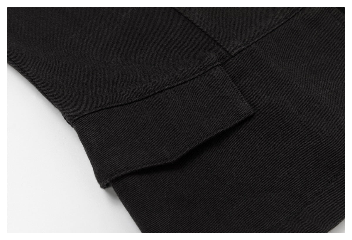 Close-up of a black sleeve cuff and stitched seam against a white background.