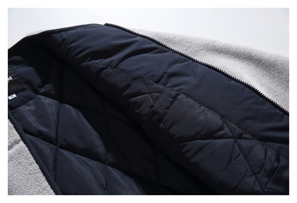 Open garment detail showing dark navy quilted lining, zipper, and light gray fleece edging.