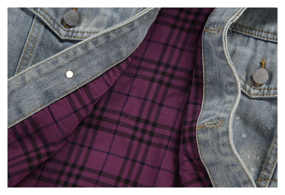 Open light blue denim jacket showing purple and black plaid lining and silver front buttons.