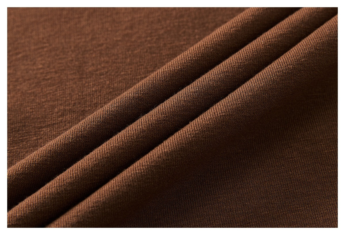 Close-up of the brown knit fabric draped in folds.