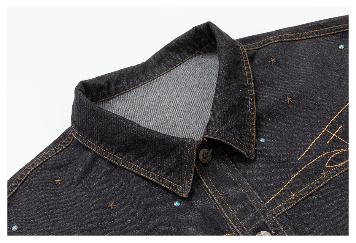 Close-up of the charcoal denim jacket's pointed collar, bronze stitching, front placket, and star and turquoise