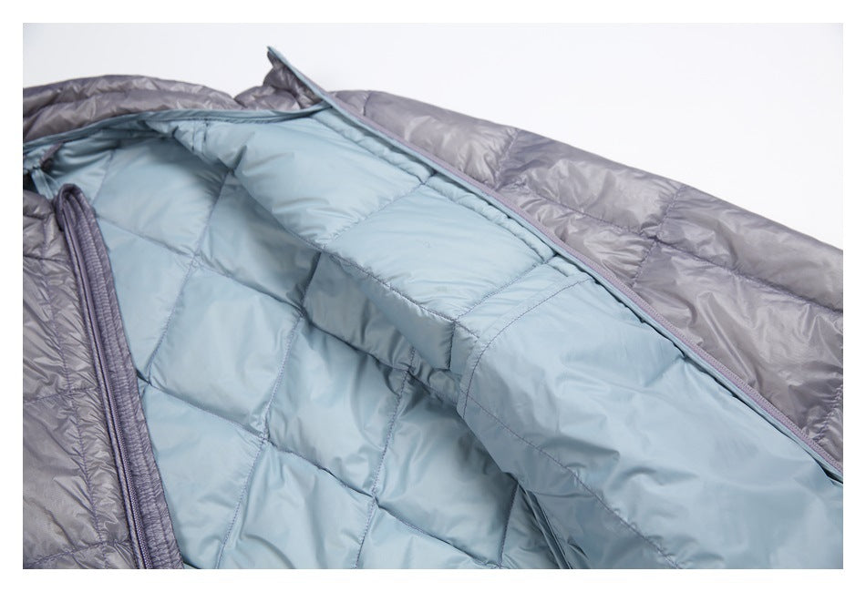 The gray quilted jacket is open, showing its pale blue quilted lining and zipper edge.