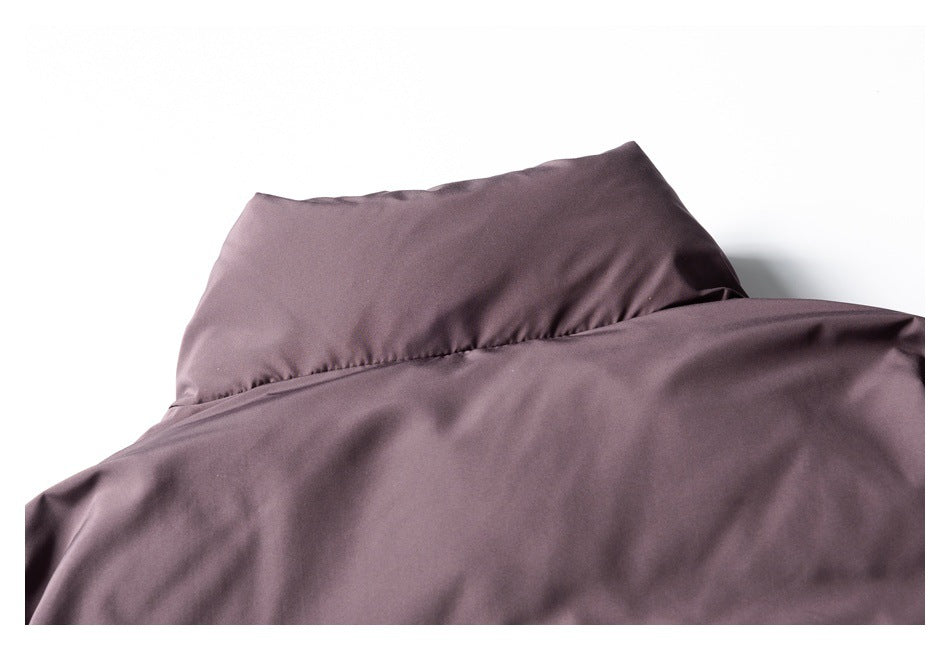 Close-up of the raised collar and upper back of a dusty mauve garment.