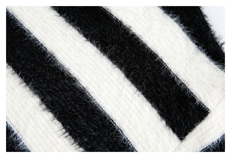 Close-up of a fuzzy black-and-ivory striped knit pattern.