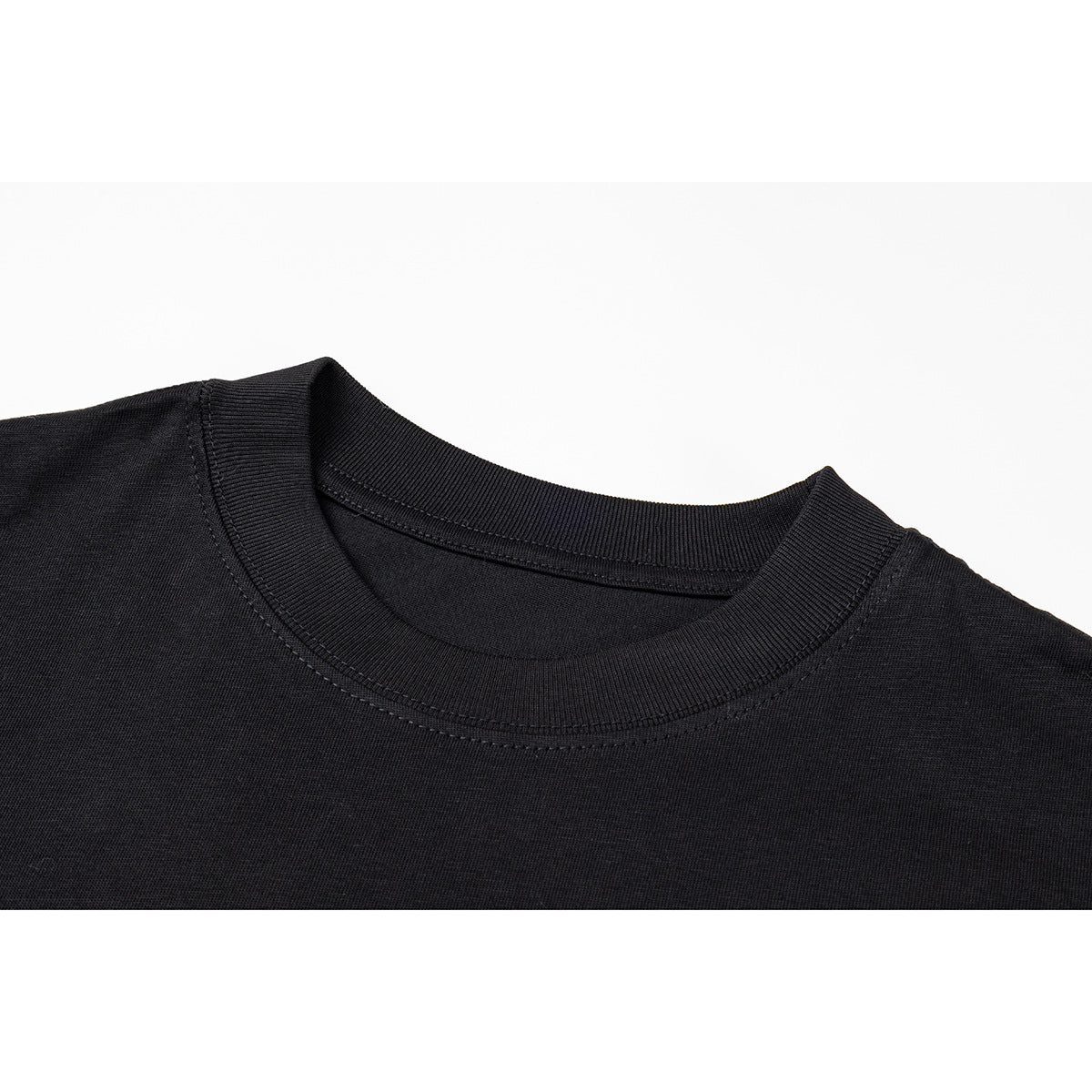 Close-up of a black T-shirt's ribbed crew neck and shoulder seams.