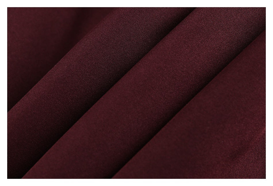 Macro view of the burgundy garment fabric showing its fine diagonal weave.