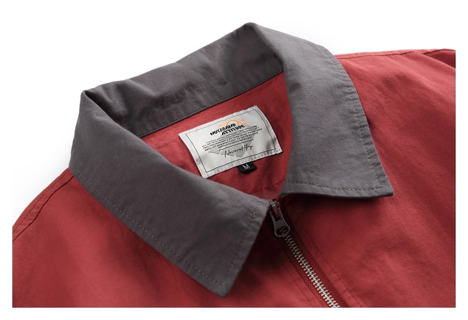 Close-up of the red jacket's charcoal collar, zipper, and sewn-in neck label.