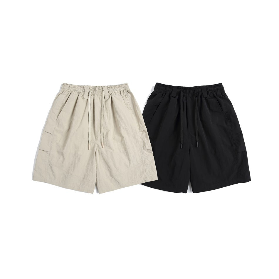 Front view of drawstring cargo shorts in beige and black, shown side by side.