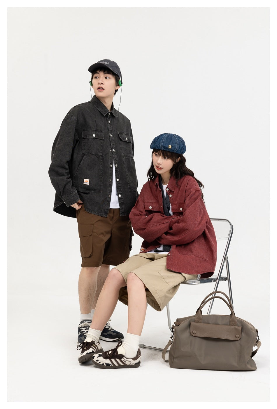 Two models wear charcoal and muted red button-front utility overshirts with chest pockets in a white studio.