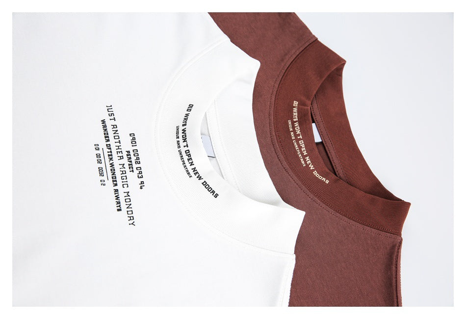 Close-up of white and burgundy T-shirt collars and chest text printed on the garments.