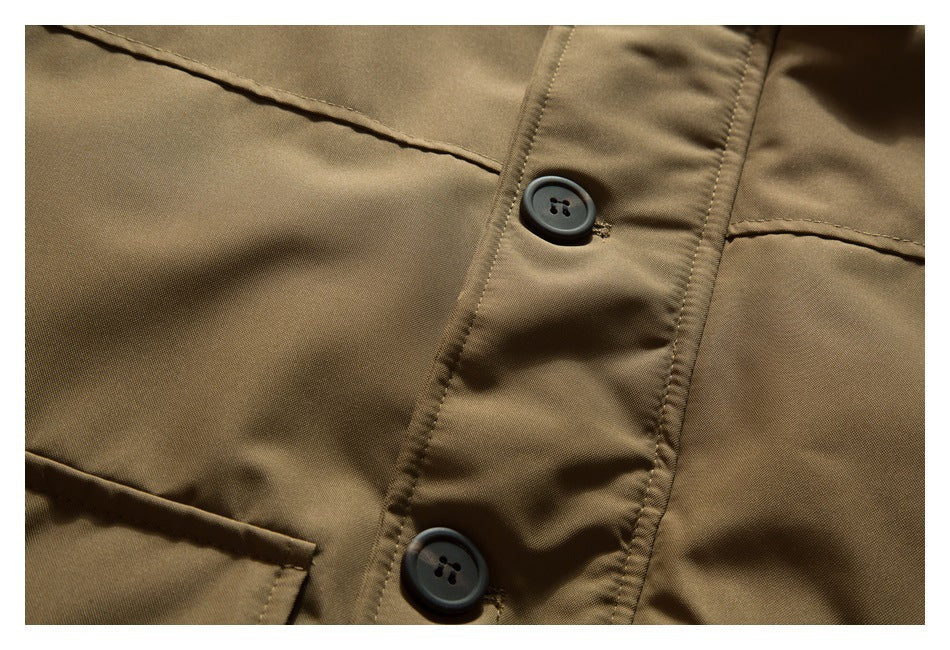 Close-up of a tan-brown garment's button placket and stitched pocket edges.